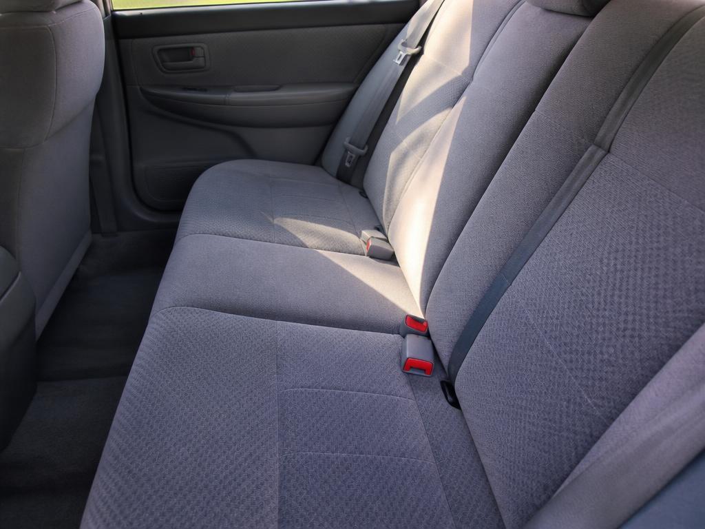 The same rear car seat cleaned and vacuumed with fresh vacuum lines
