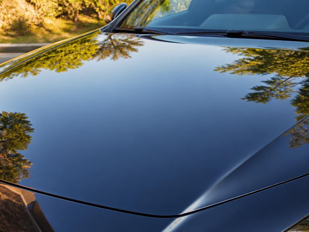 The same car hood after correction, deep glossy reflective finish